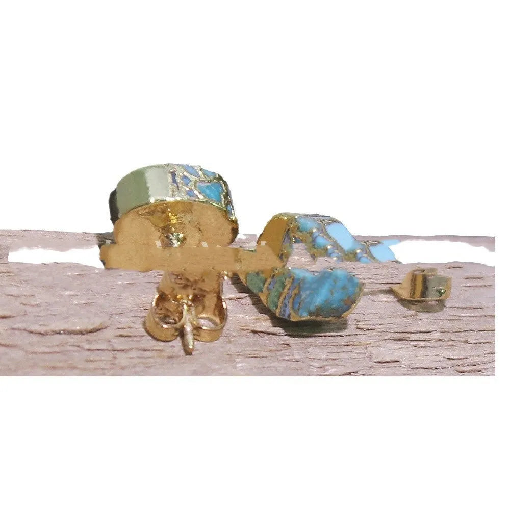 Close-up of handcrafted natural stone bohemian stud earrings with irregular shape on a plain background.