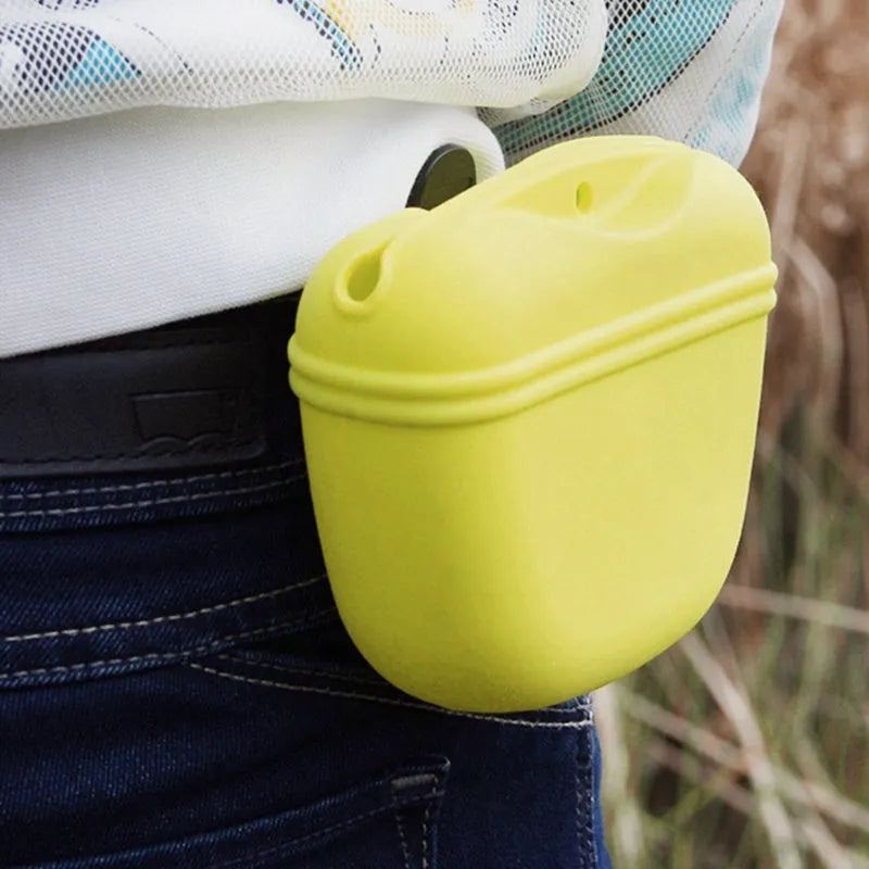 Coloured silicone dog treat bag with clip and magnetic opening, shown with dog training treats.