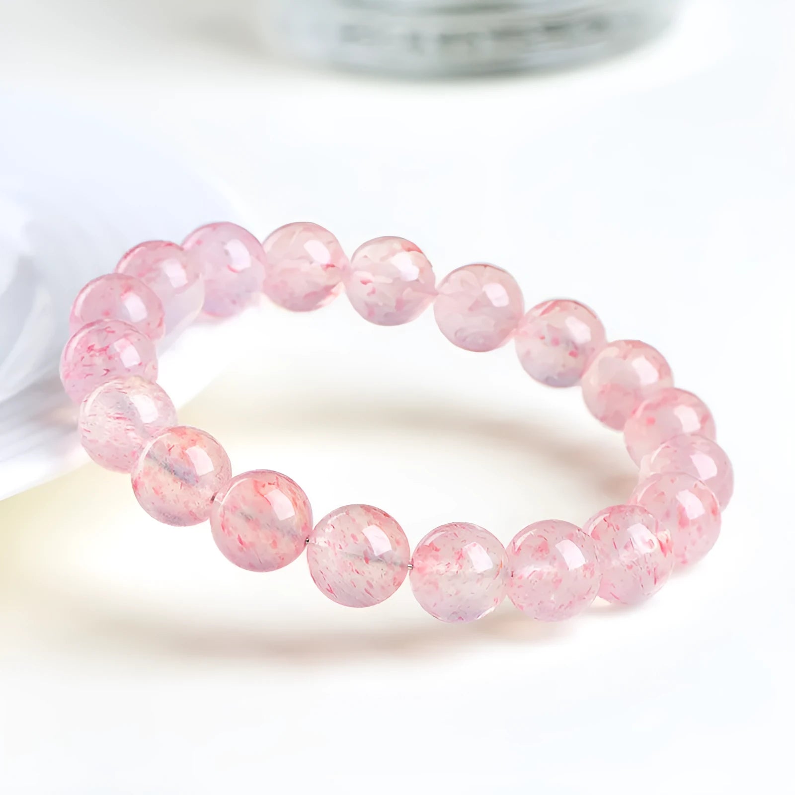 Strawberry quartz crystal bracelet with 10-10.8mm round beads in white water colour