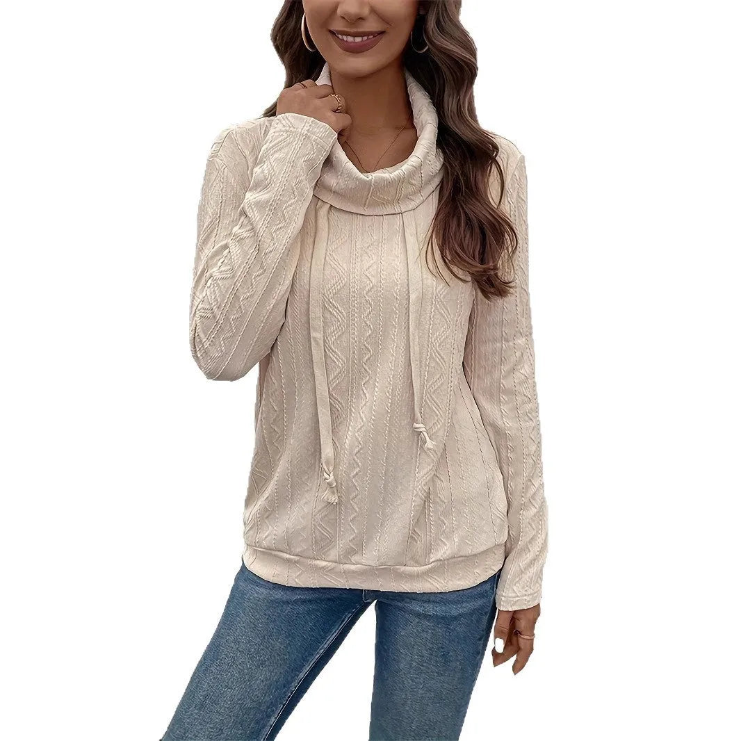 Apricot coloured pullover sweater with a drawstring hood and long sleeves laid flat.