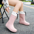 Women's PVC rain boots with non-slip soles in apricot, black, brown, or pink colours