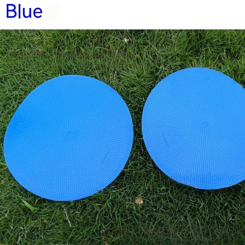 Yellow TPE football training target disc on grass, 23cm diameter flat landmark pad