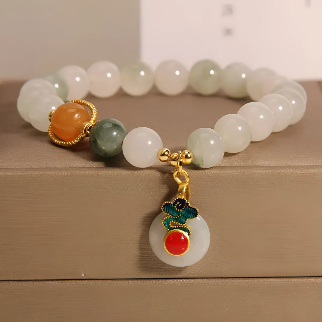 Women's ice jade bracelet with pearl accents and carved Xiangyun peace jade buckle