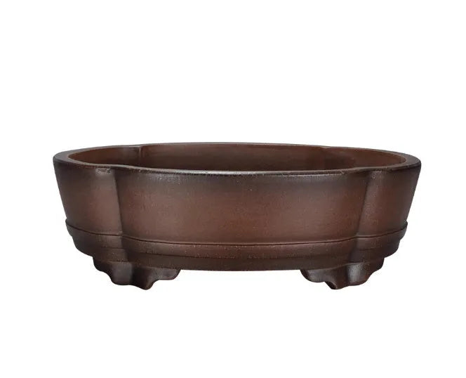 A classical simple purple clay bonsai pot on a tabletop.