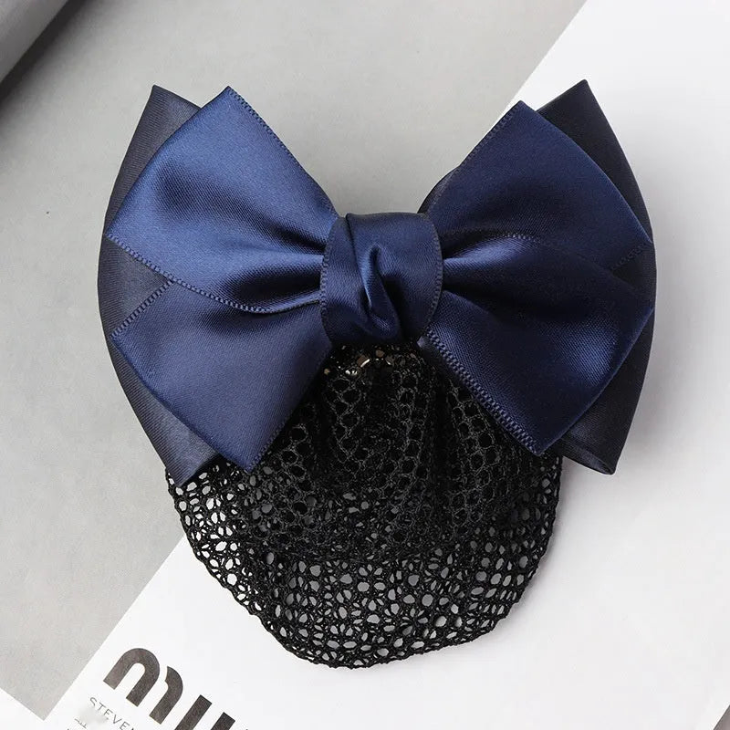 Professional hair clip with a black net pocket and a red flower bow ornament on a white background.