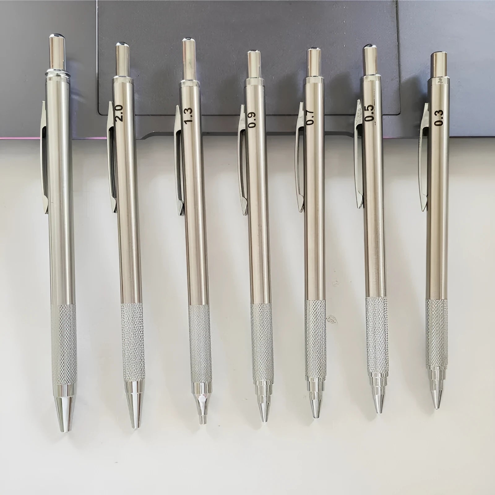 Metal automatic mechanical pencil with various lead specifications displayed