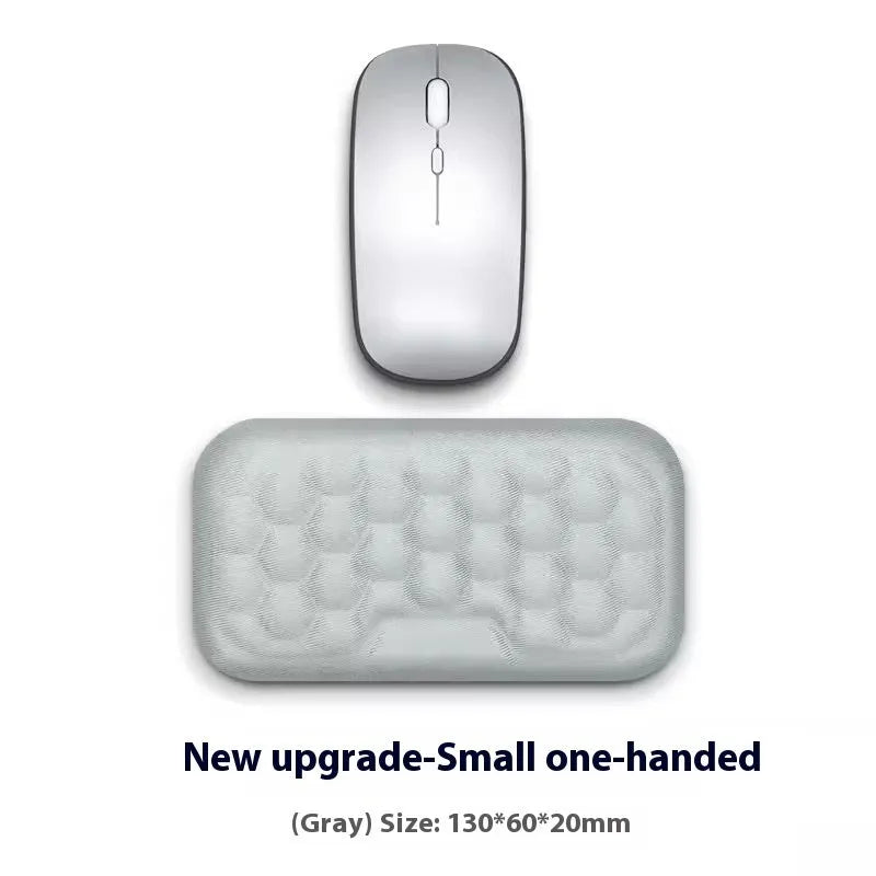 Customisable memory foam mouse wrist pad with black cloth cover on a desk.