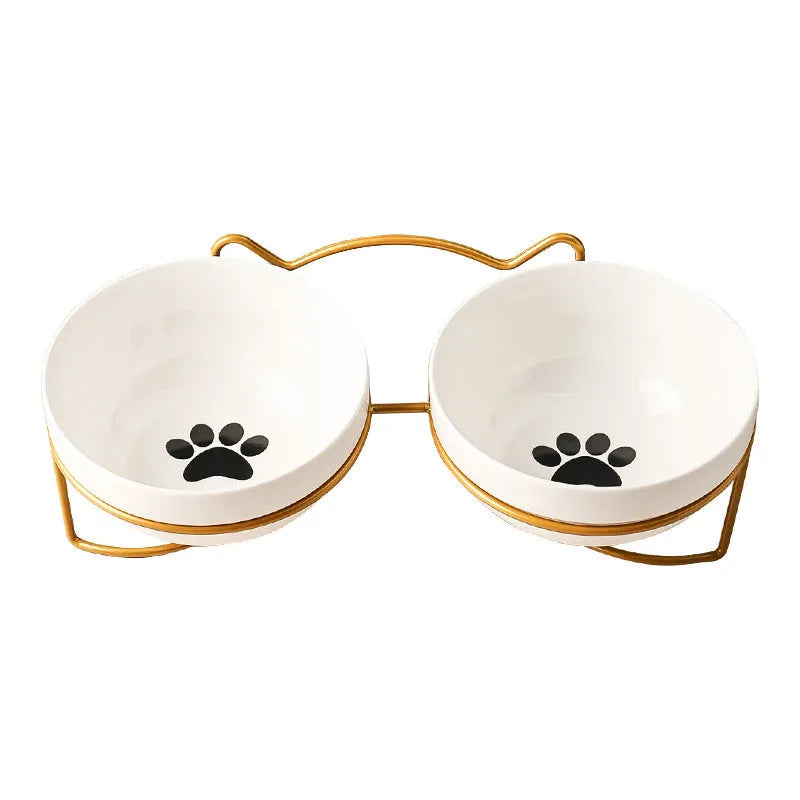 Ceramic cat bowl with iron frame stand showing cat paw print pattern and gold metal finish