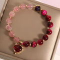 Women's strawberry crystal bracelet on elastic rope showing natural bead texture and uniform 18cm size