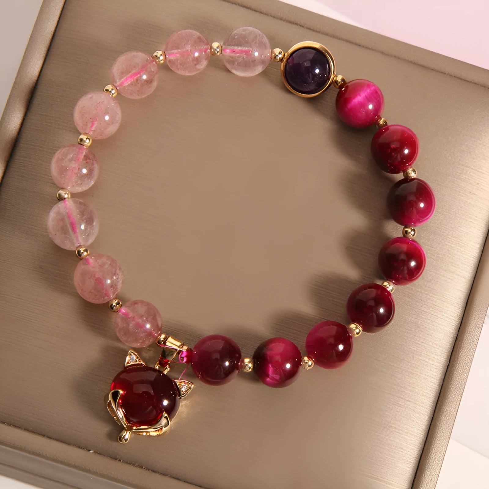 Women's strawberry crystal bracelet on elastic rope showing natural bead texture and uniform 18cm size