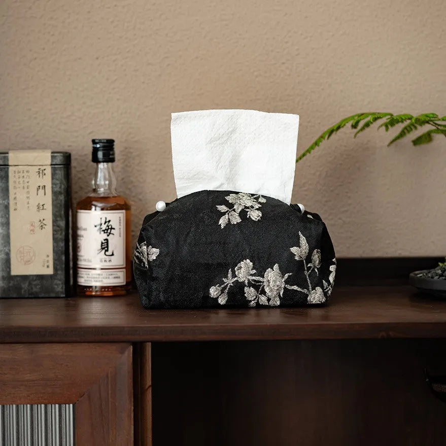Chinese brocade fabric tissue box with embroidered white plum pattern, approximately 17 cm wide