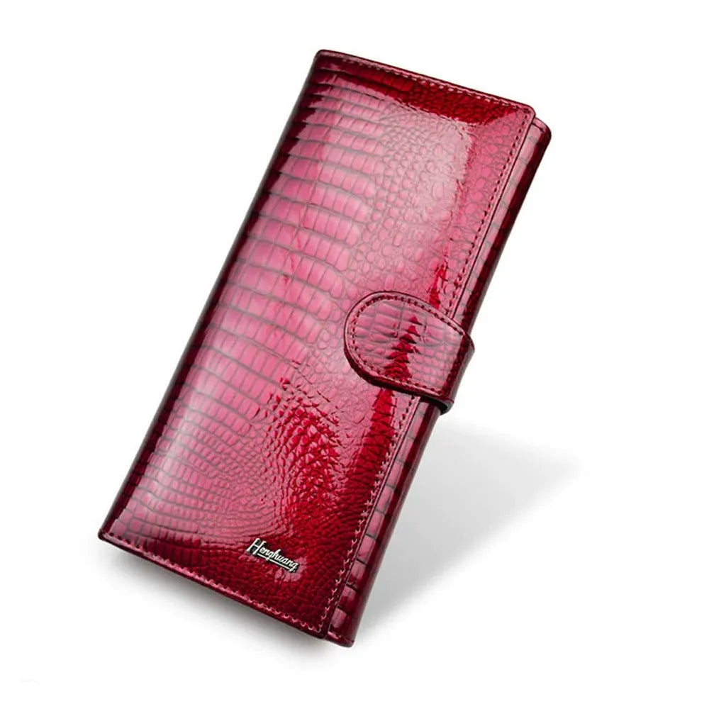 Women's red patent leather coin purse with crocodile pattern texture.