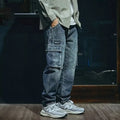 Men's blue loose straight-leg denim trousers with zip fly on mannequin