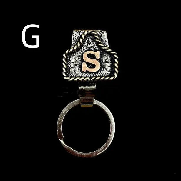 Handmade metal cow tag key holder for belts in assorted colours on a leather strap