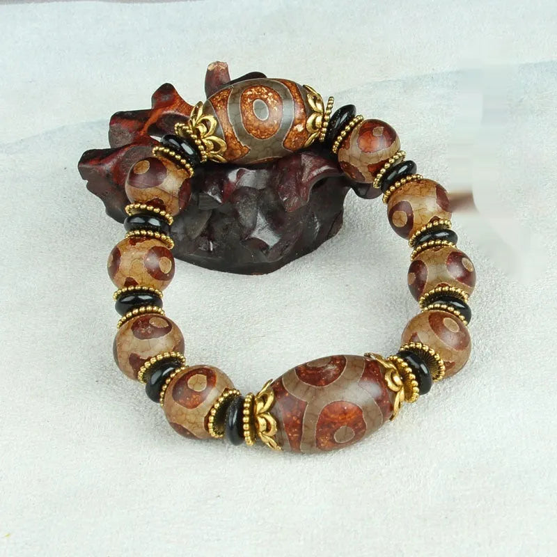 Agate Tibetan dzi bead bracelet with three-eye design and polished finish