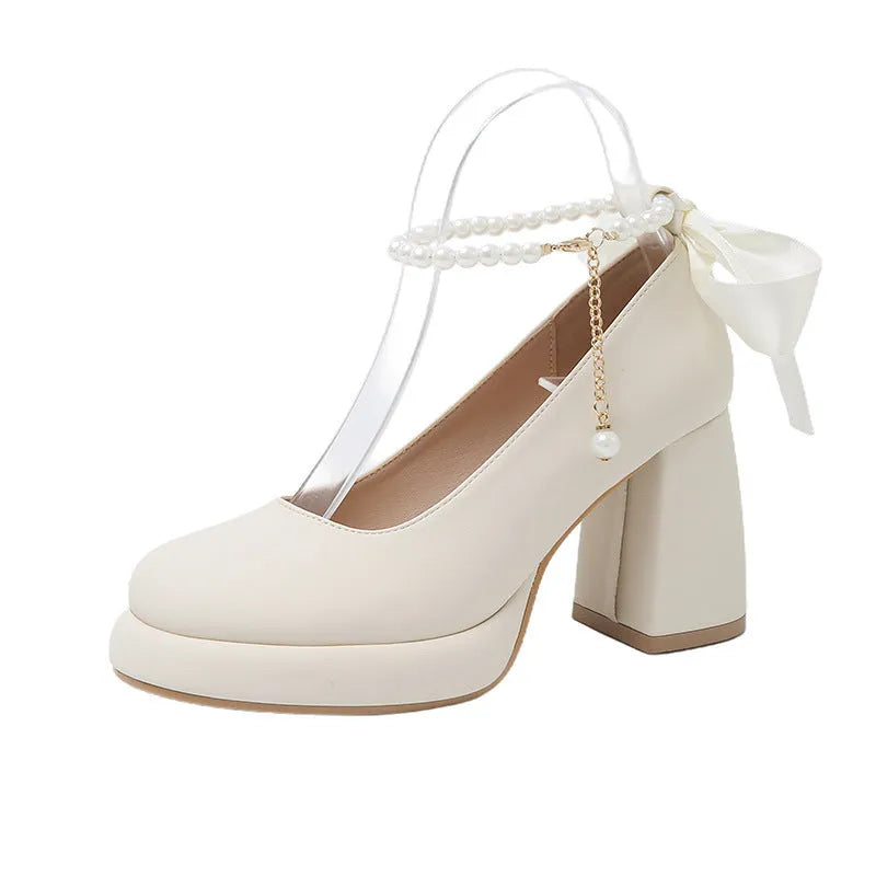 Women's beige Mary Jane shoes with chunky heel and ankle-strap buckle on a white background