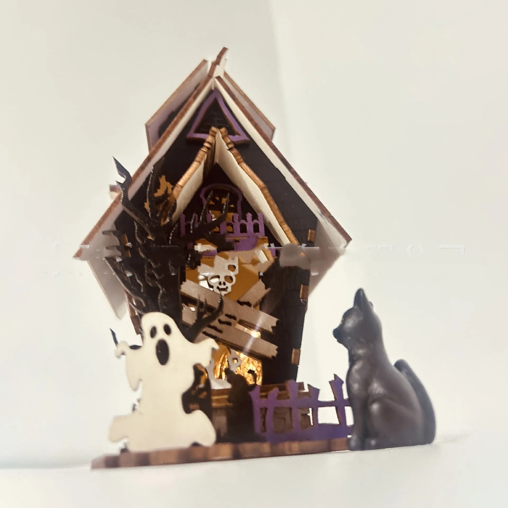 Wooden DIY Halloween haunted house table decoration with glow-in-the-dark details, shown unpainted.