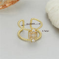 Gold plated open ring with U-shaped asymmetric design and adjustable opening.