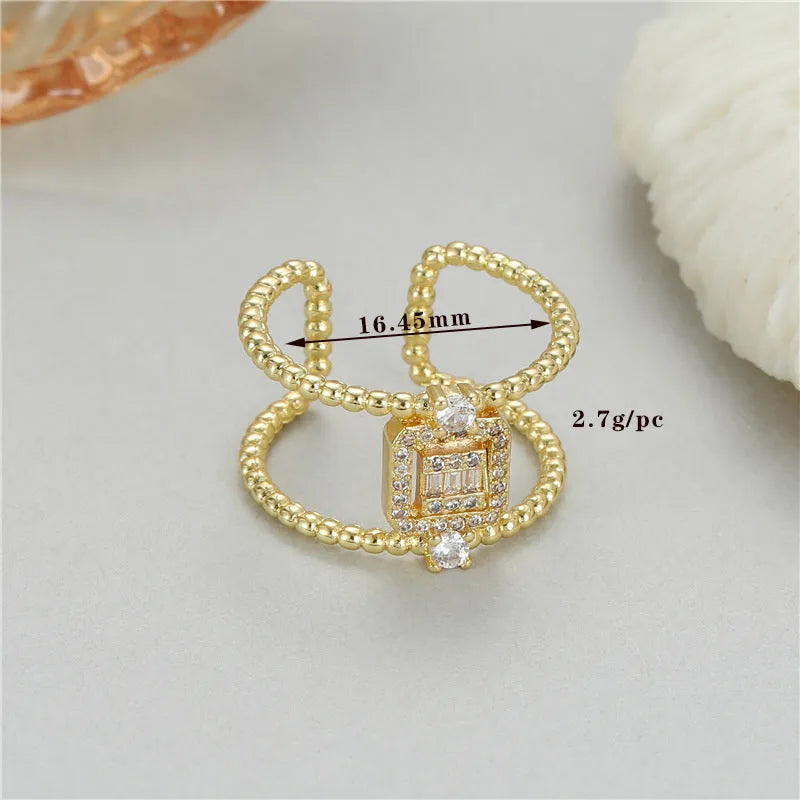 Gold plated open ring with U-shaped asymmetric design and adjustable opening.