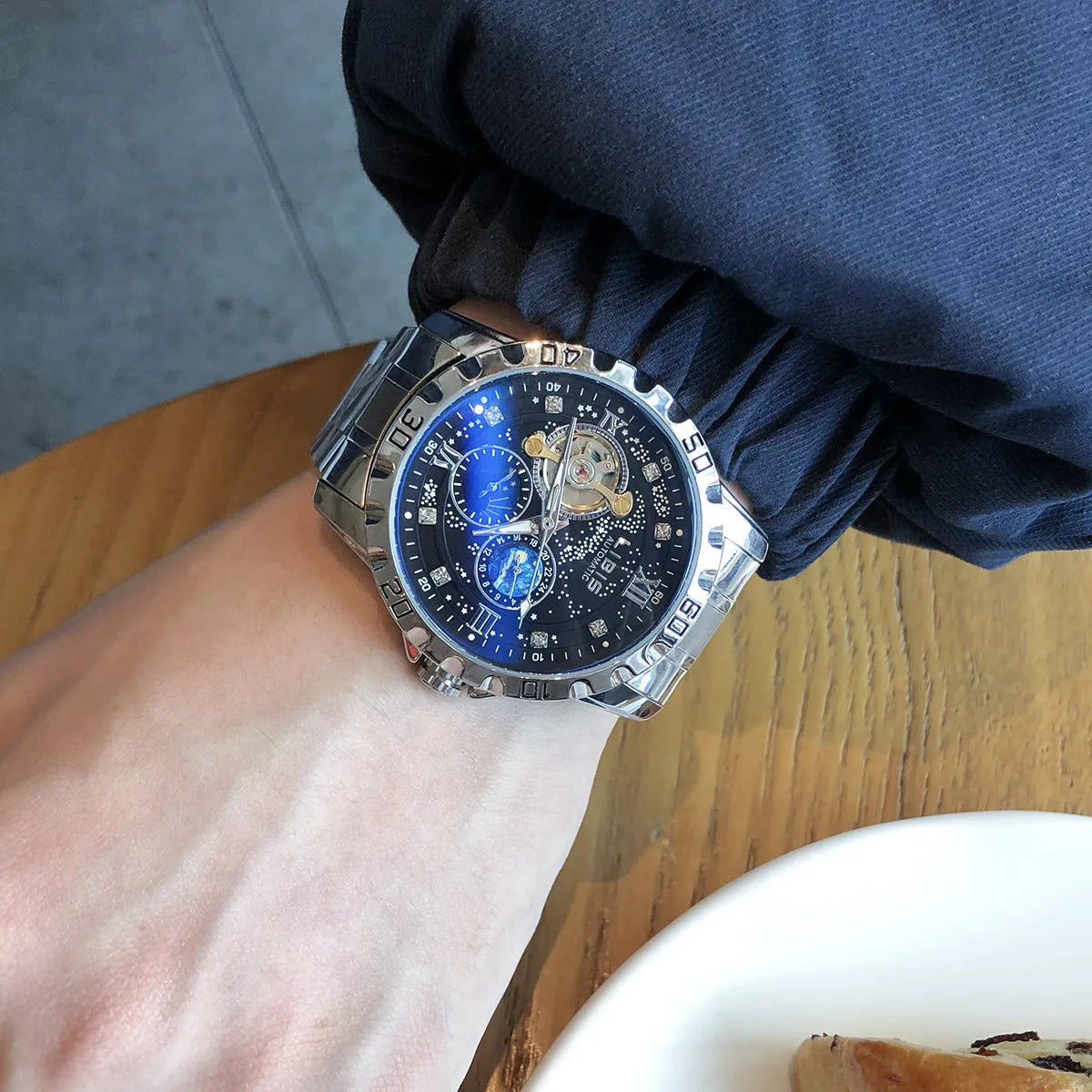 Men's silver case black dial automatic mechanical watch with luminous hands and transparent caseback