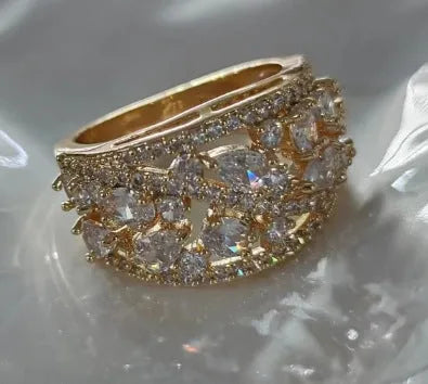 Women's hollow round fashion ring in gold or platinum finish with blue or white accents on a copper band.