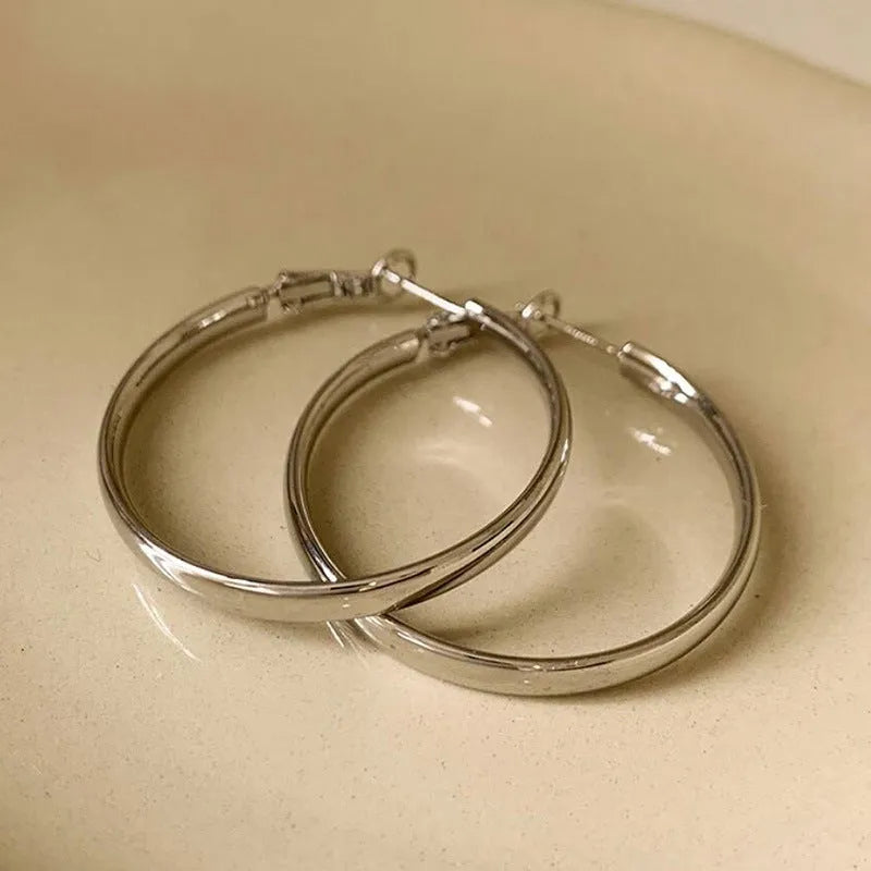 Circular 40mm diameter metal earrings with gold or silver electroplated finish