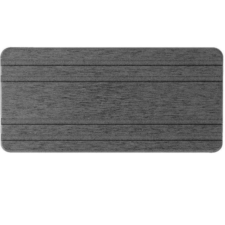 Three square diatomite bathroom draining pads in solid colours on a countertop