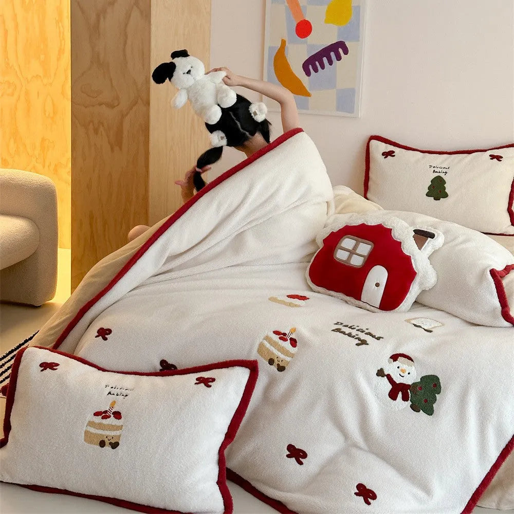 Winter Christmas cartoon patterned bed linen four-piece set on a bed, showing duvet cover and pillowcases.