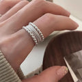 Copper alloy adjustable opening ring with woven twisted multilayer geometry design