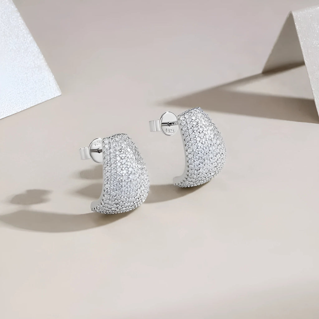Geometric S925 sterling silver ear studs with moissanite centre on a white background.