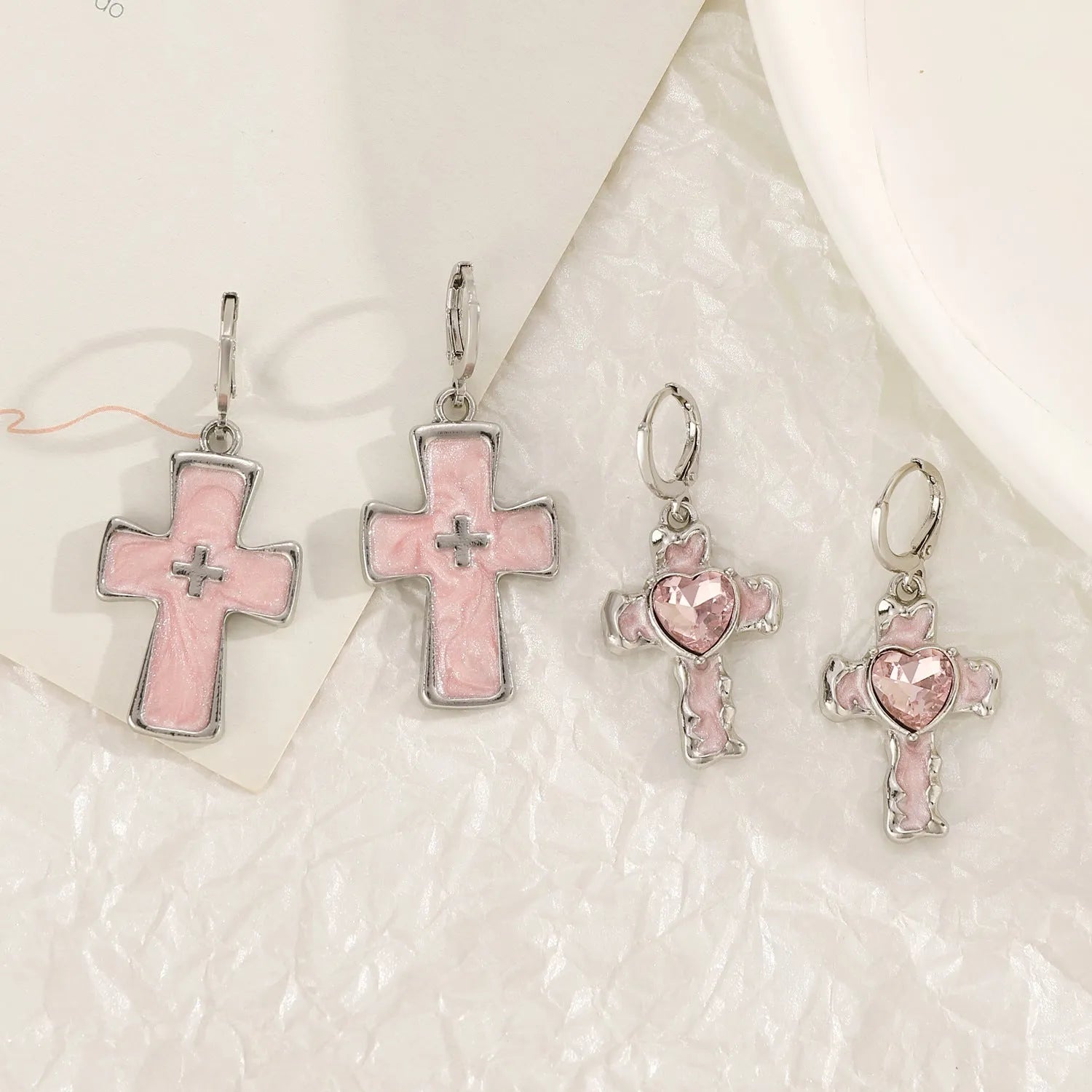 Women's alloy earrings with cross and heart designs in white and antique silver colour variants