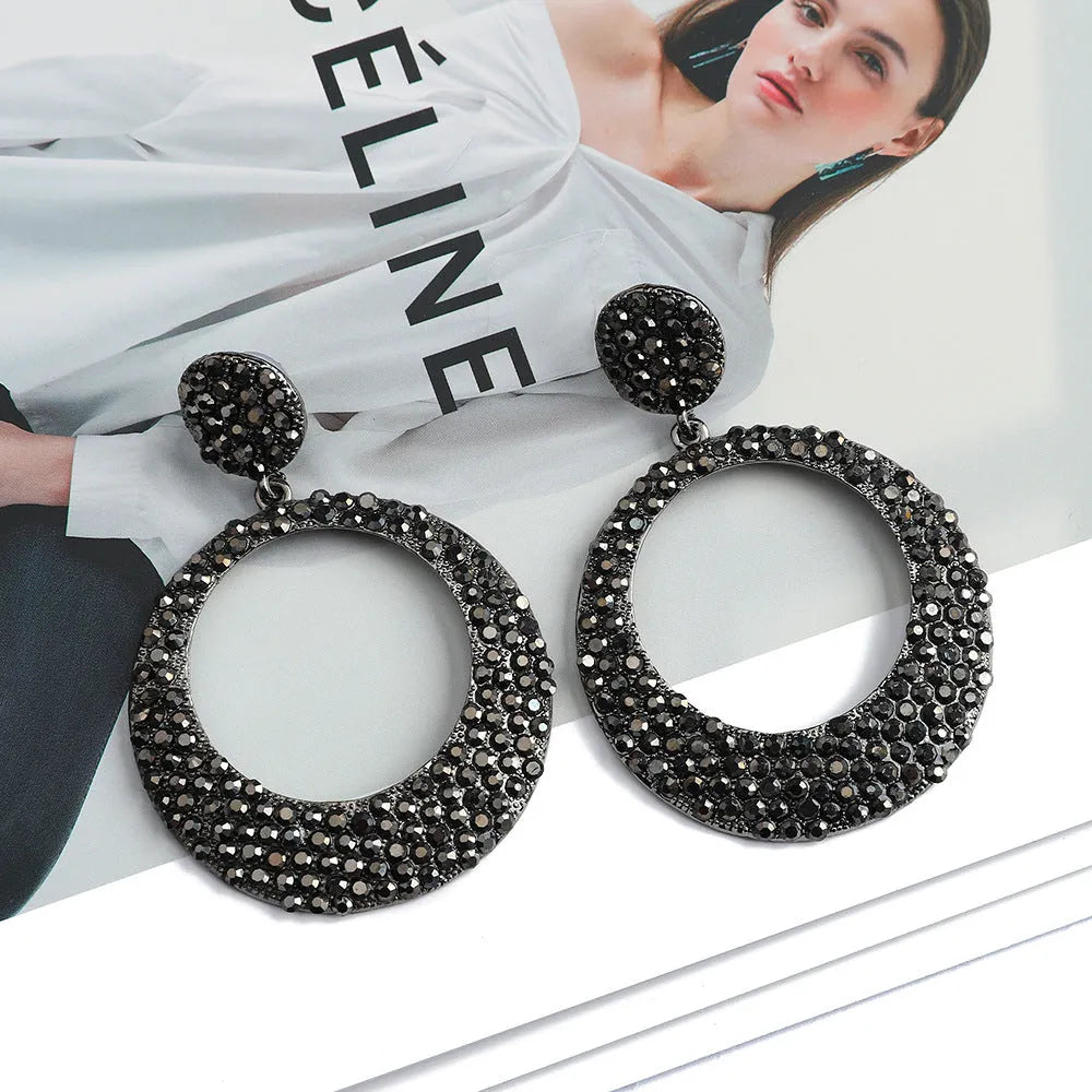 Colourful metal pendant earrings with diamond accents and cartoon style design