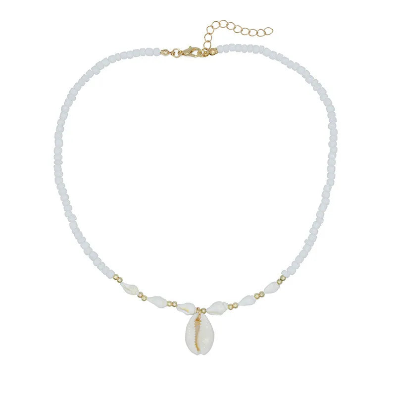 Close-up of a white conch shell bead necklace for women, showing the mother pearl shellfish pendant on a regular chain.
