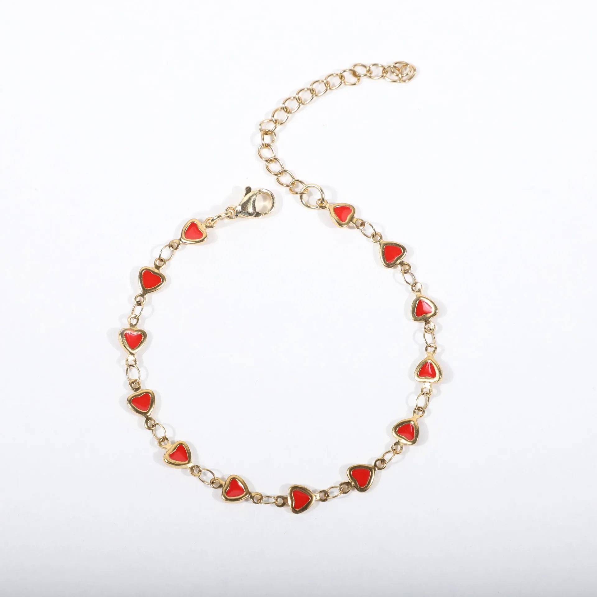 Stainless steel heart-shaped bracelet with gold plating in multiple colour options on a wrist.