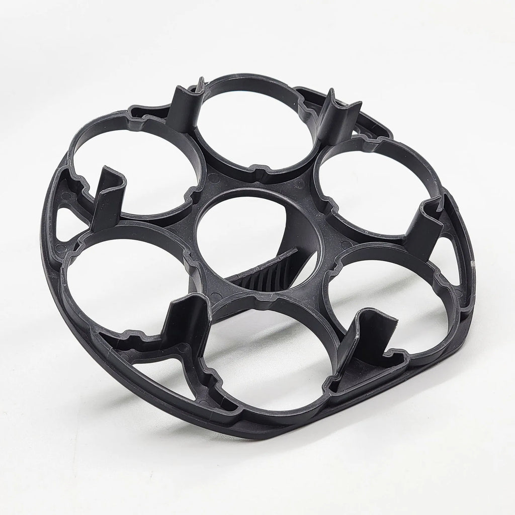 Black plastic egg holder basket rack for a cooking machine on a white background.
