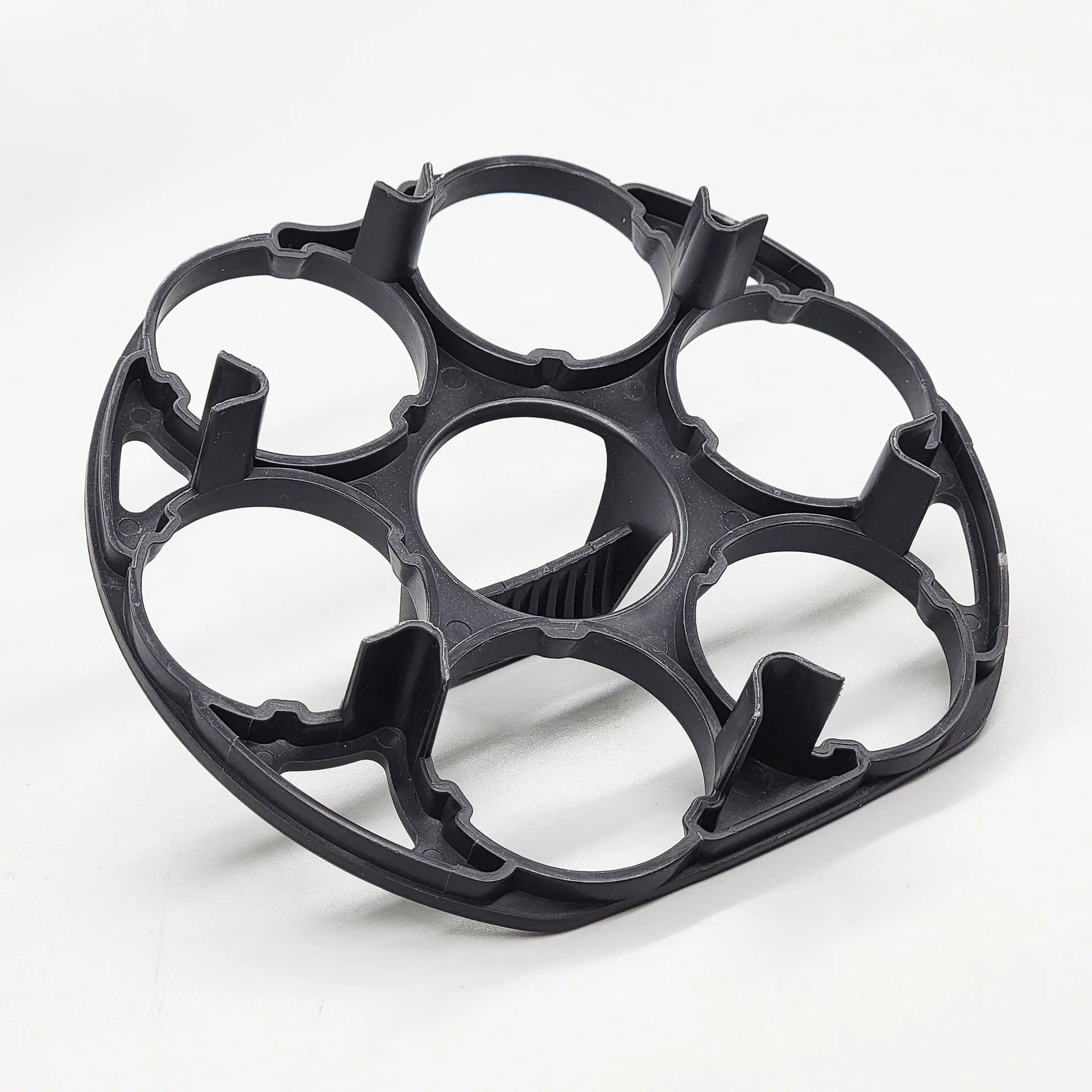 Black plastic egg holder basket rack for a cooking machine on a white background.
