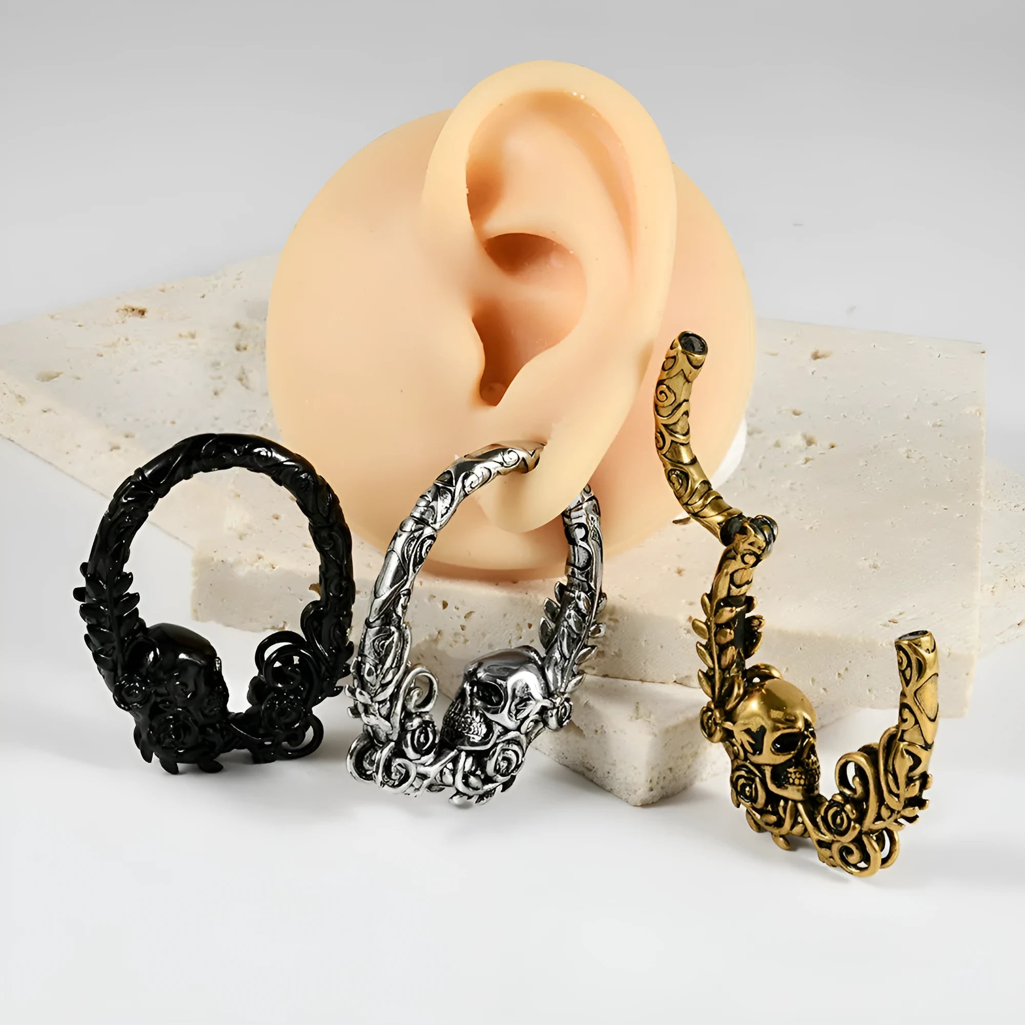 A pair of silver-toned fashion earrings with a geometric totem pattern design on a white background.