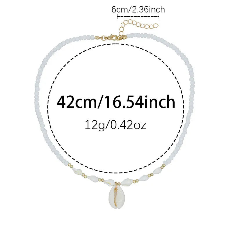 Close-up of a white conch shell bead necklace for women, showing the mother pearl shellfish pendant on a regular chain.