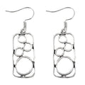 A pair of antique silver round ring earrings with a geometric irregular square design.
