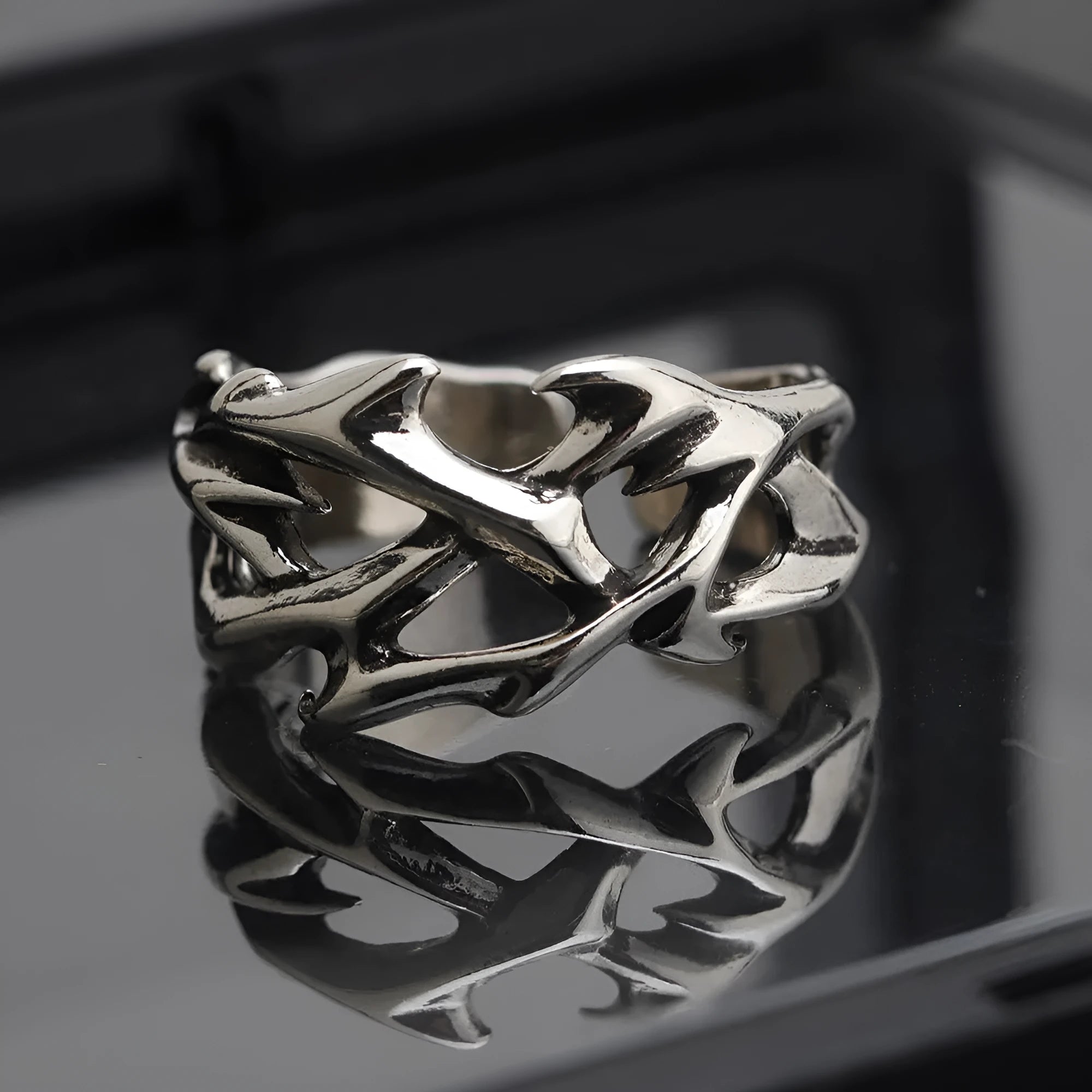 Geometric copper ring with thorn and flower design featuring adjustable opening
