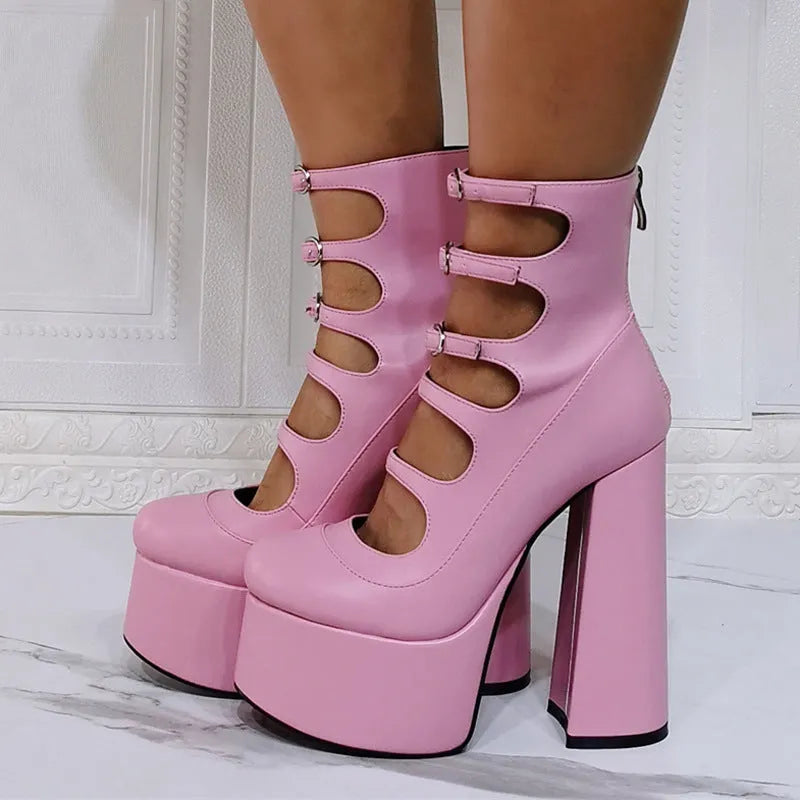 Women's black patent leather platform high heel boots with a serpentine belt buckle fastened around the ankle.