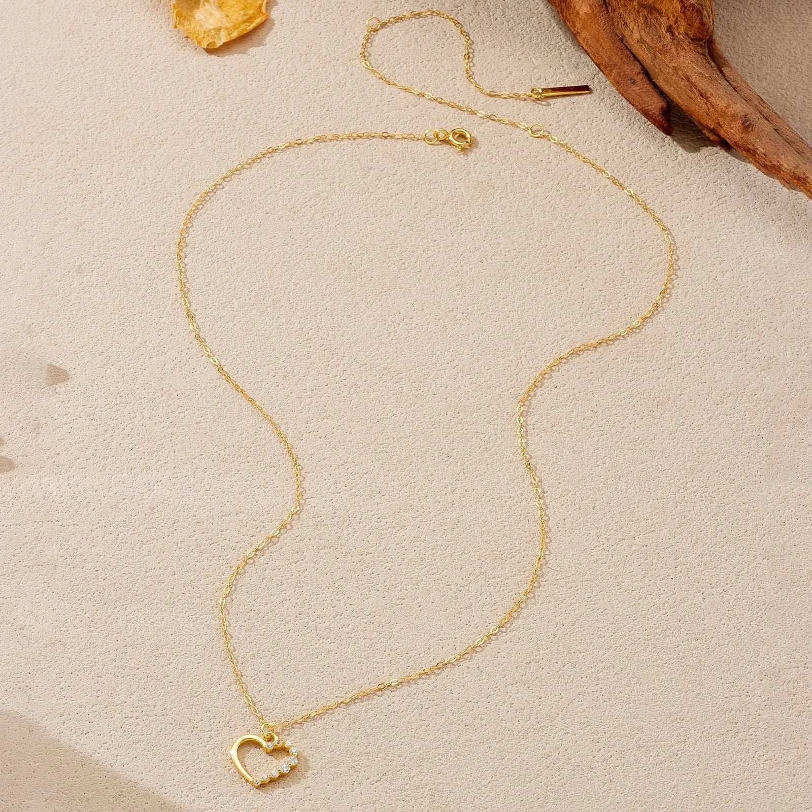 S925 sterling silver hollow heart pendant necklace on a regular chain, available in white gold or 18K gold finish.