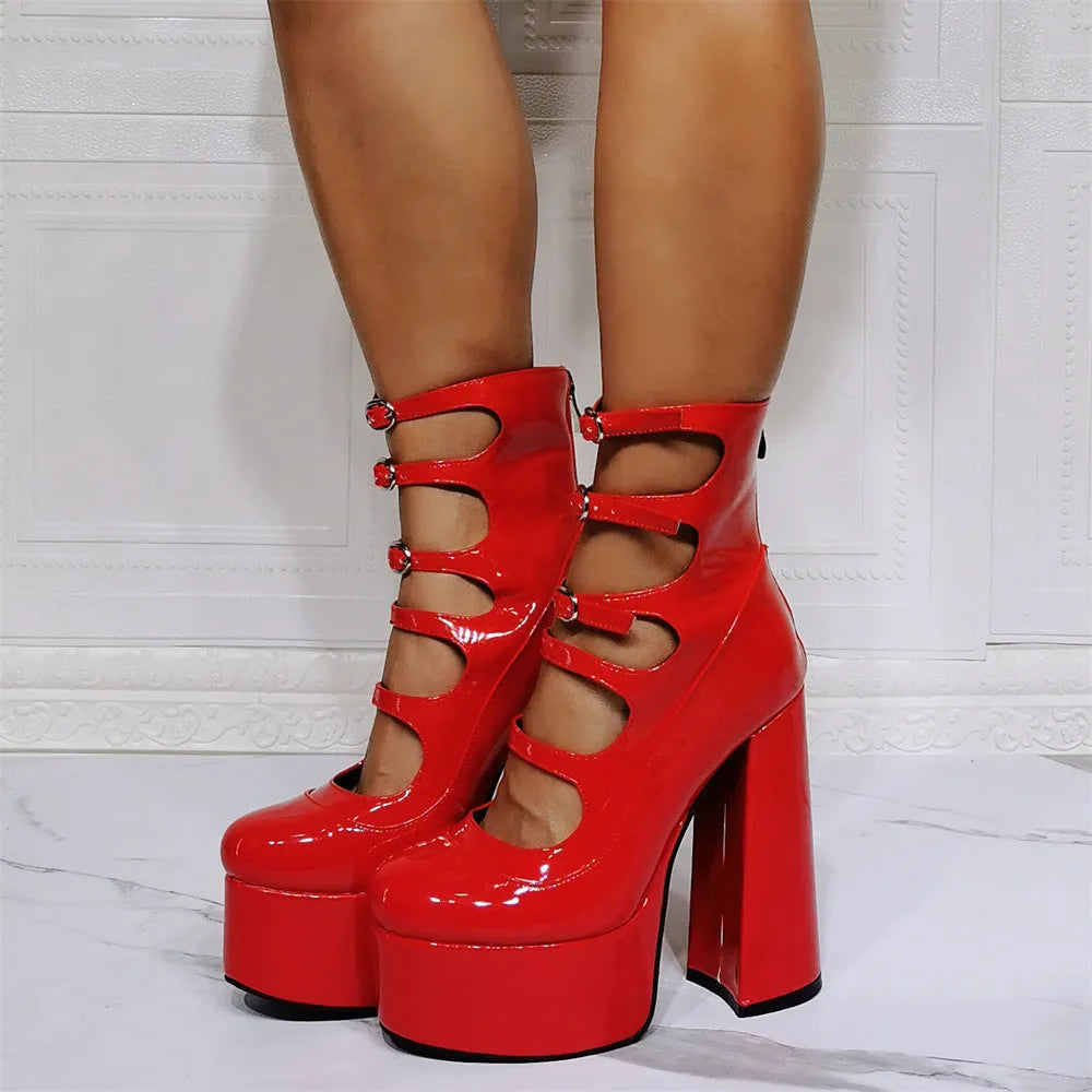 Women's black patent leather platform high heel boots with a serpentine belt buckle fastened around the ankle.