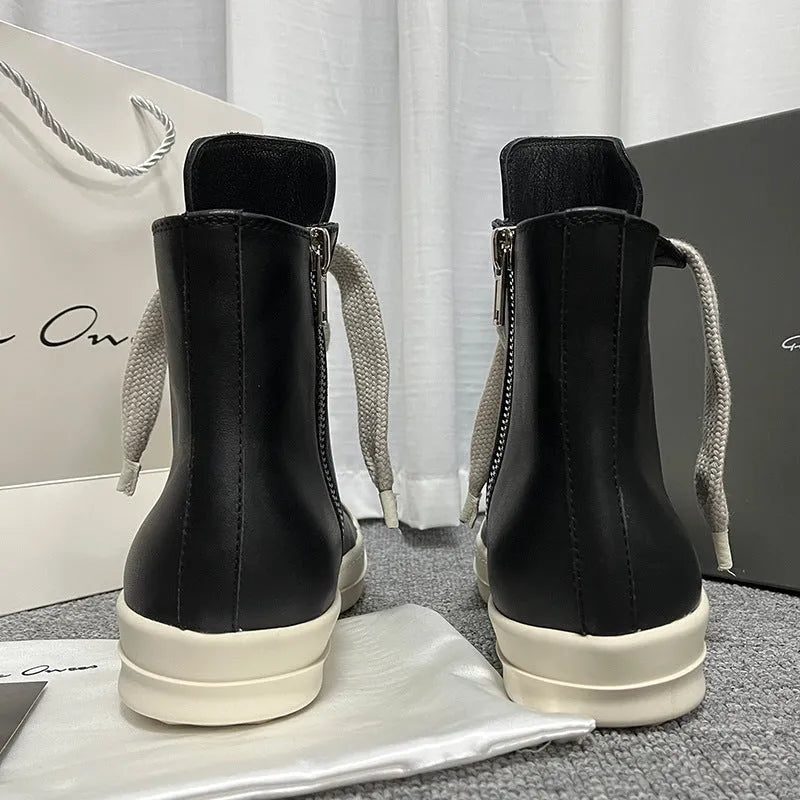 Genuine leather high-top sneakers with side zipper in black, shown on a casual outfit.