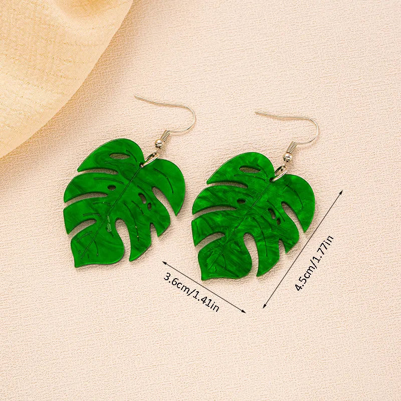 Acrylic drop earrings with a carved coconut and jackfruit design on a metal hook, shown in multiple colour variants.