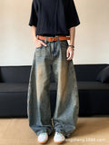 Man wearing retro blue distressed wide-leg denim jeans with a mid waist and zipper fly.