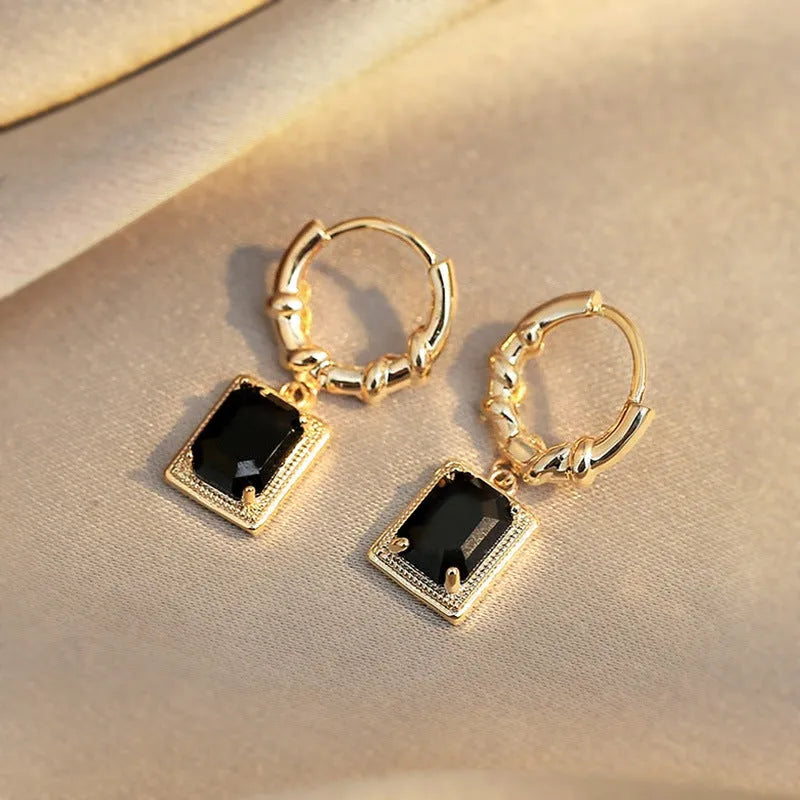 A pair of black geometric quadrilateral earrings with zircon accents on a copper base, retro French court style.
