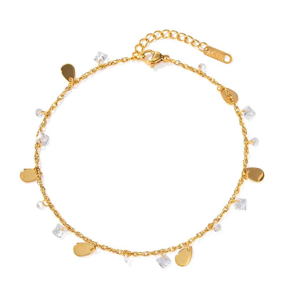 Silver stainless steel women's anklet with geometric and water drop tassel charms.