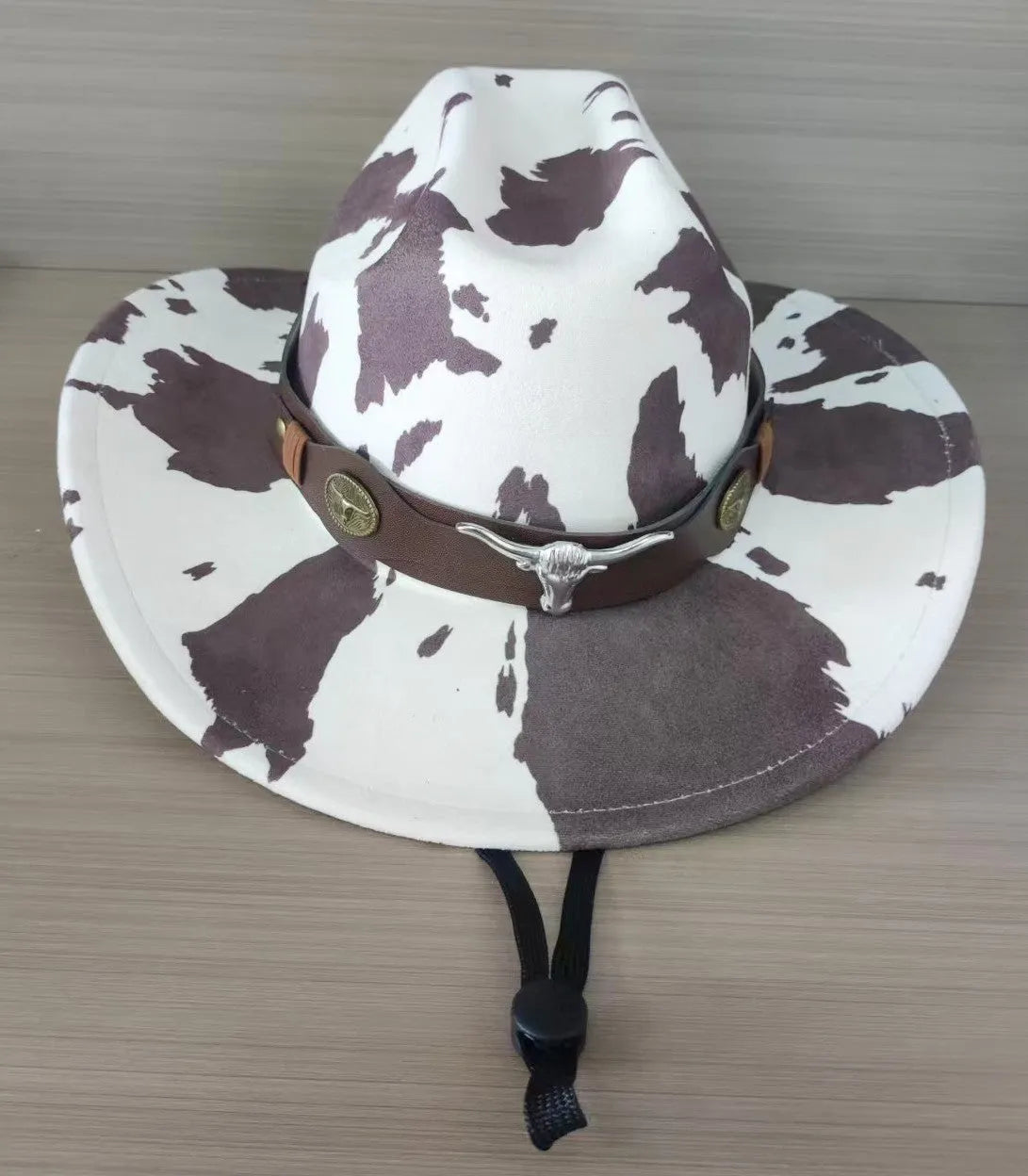 Brown leather velvet cowboy hat with a curved edge and conical crown on a plain background.