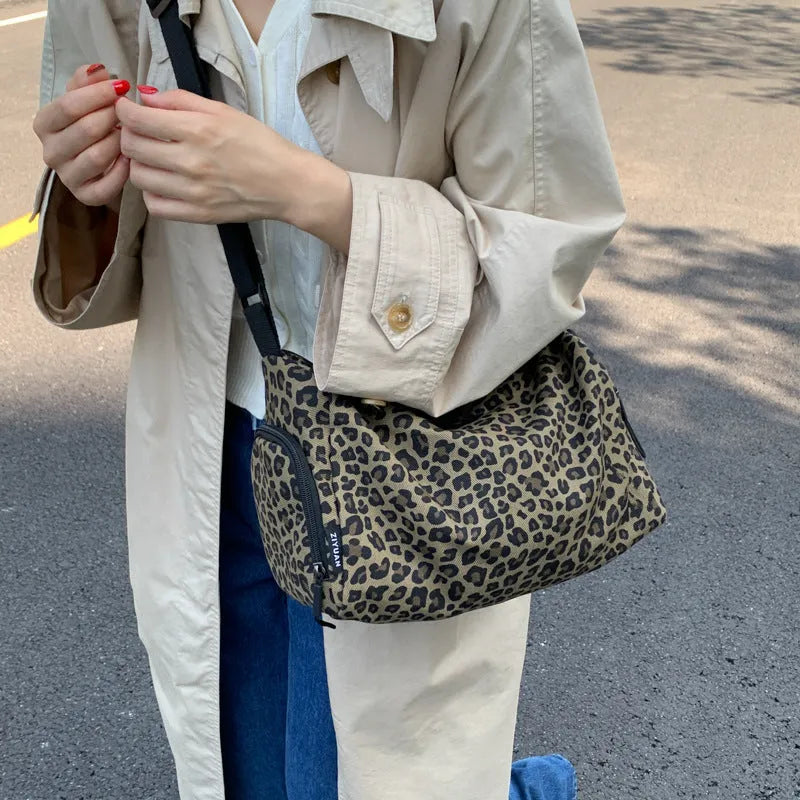 Sports style shoulder messenger bag in leopard print pattern with cross-body strap